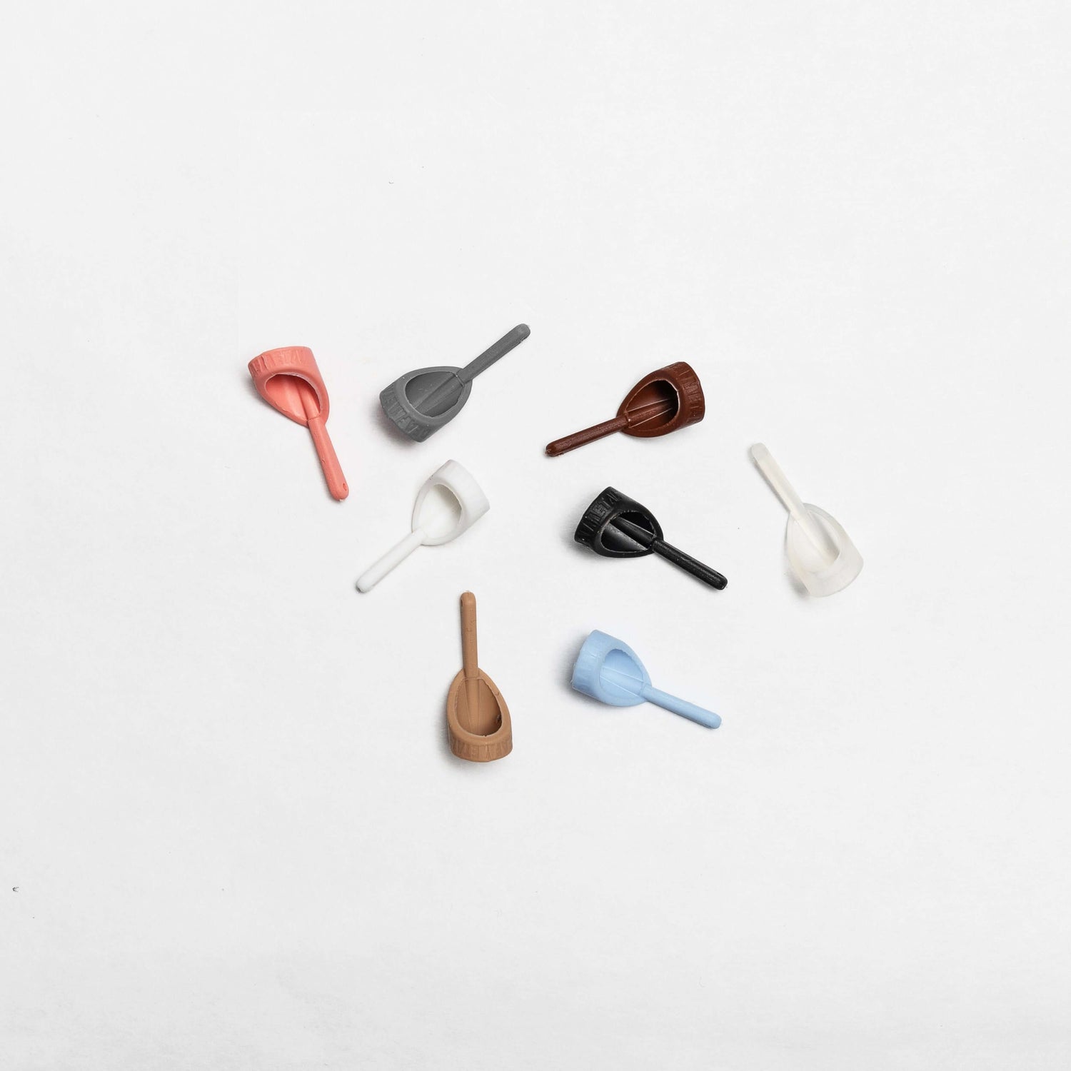 Silicone fasteners for connecting Deafmetal jewelry to hearing aids and cochlear implants, available in multiple colors.