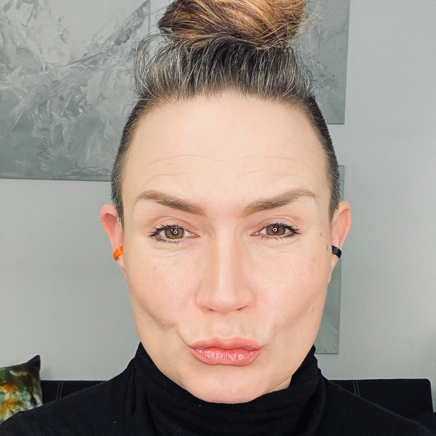 woman wearing a black and orange Deafmetal insurance clips